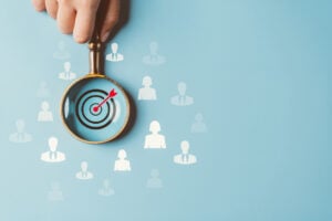HRM or Human Resource Management, Magnifier glass focus to manager business icon which is among staff icons for human development recruitment leadership and customer target group concept. Australia | Insights