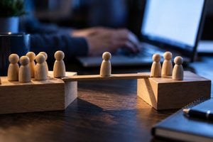 wooden-figures-bridging-teamwork United Kingdom | Know your people: The migration is easy. The humans are hard